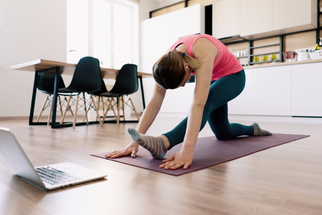Woman practising yoga at home