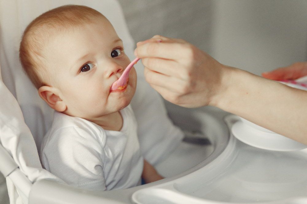Baby feeded with spoon