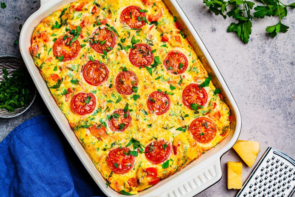 Traditional-egg-frittata-with-tomatoes-cheese-oven-dish-top-view-baked-omelet-with-vegetables-cheese