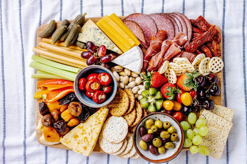 Charcuterie-board-with-cold-cuts-fresh-fruits-cheese-close-up
